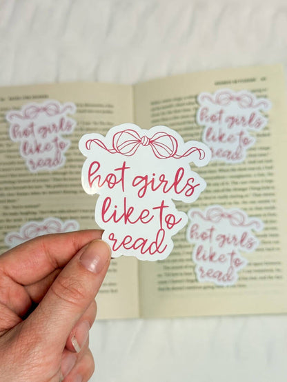 Boekenliefhebbers sticker met de tekst 'Hot girls like to read' in speelse roze letters met een strik erboven, ideaal voor bookish decoratie.
